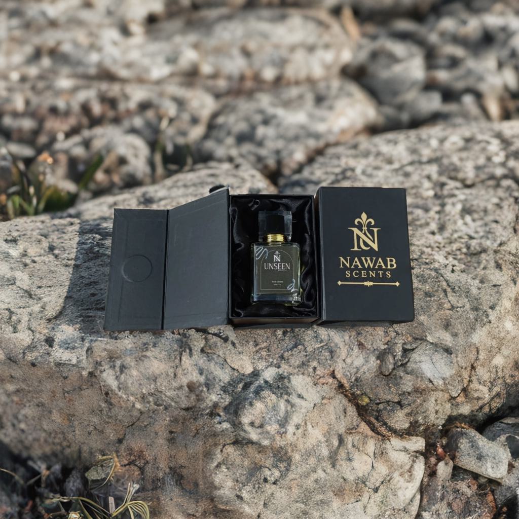 Perfume bottle in a black box with 'Nawab Scents' branding on a rocky surface